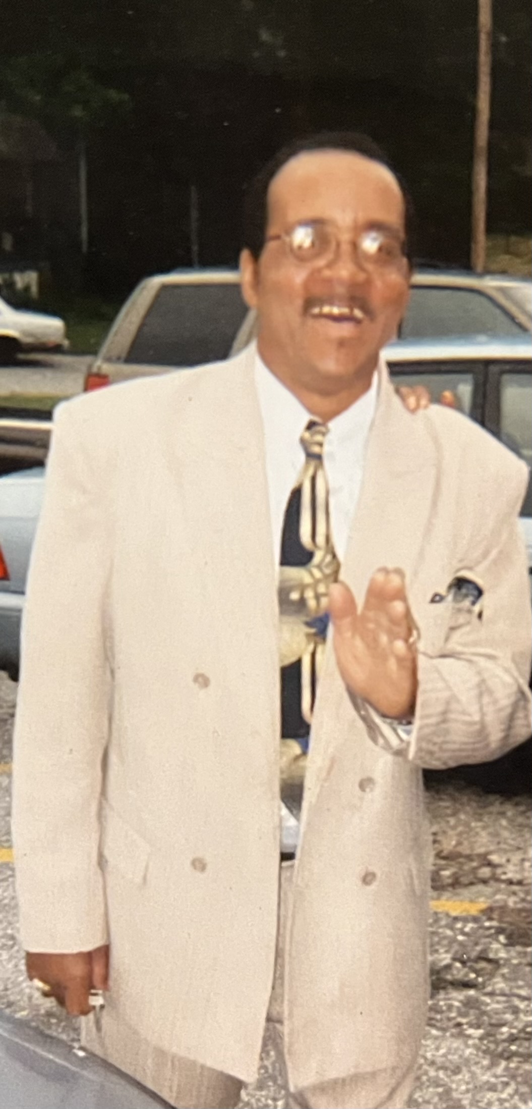 Pastor Archie McHerring in a light-colored suit